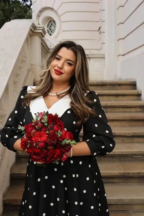 Portrait of a woman holding red roses