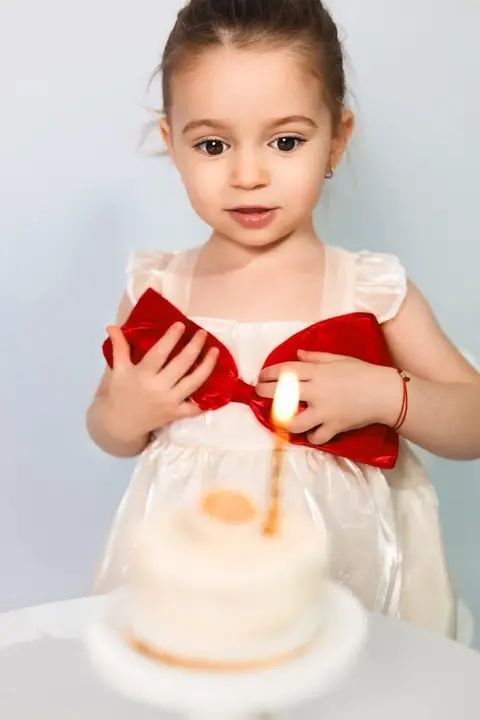 Toddler with a birthday cake and candle