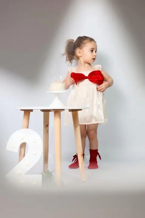 Little girl standing beside a number two stool